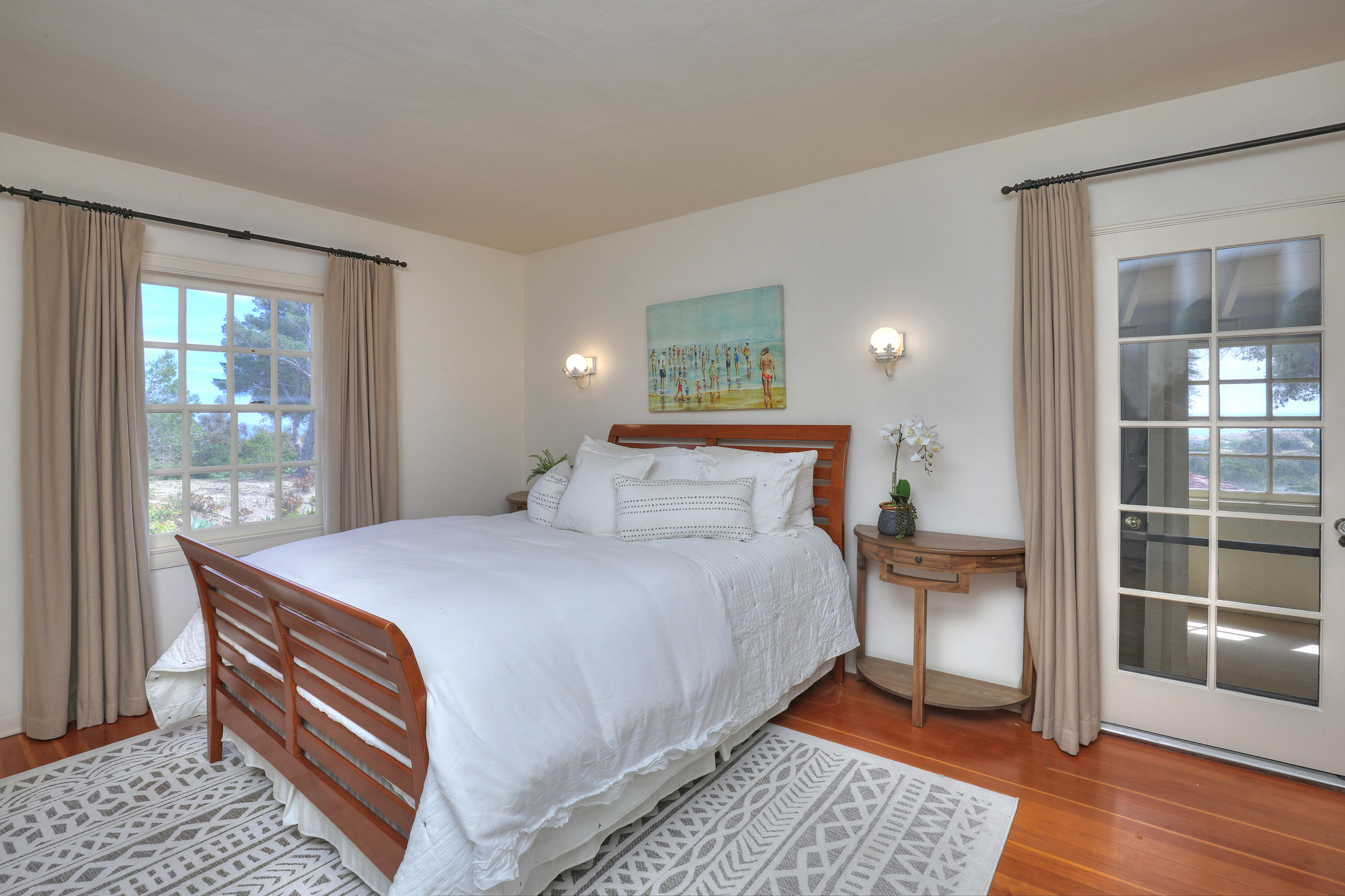 71 Hollister Ranch Road Lompoc, CA 93436 - Photo 18 of 31 a bedroom with a bed and wooden floor