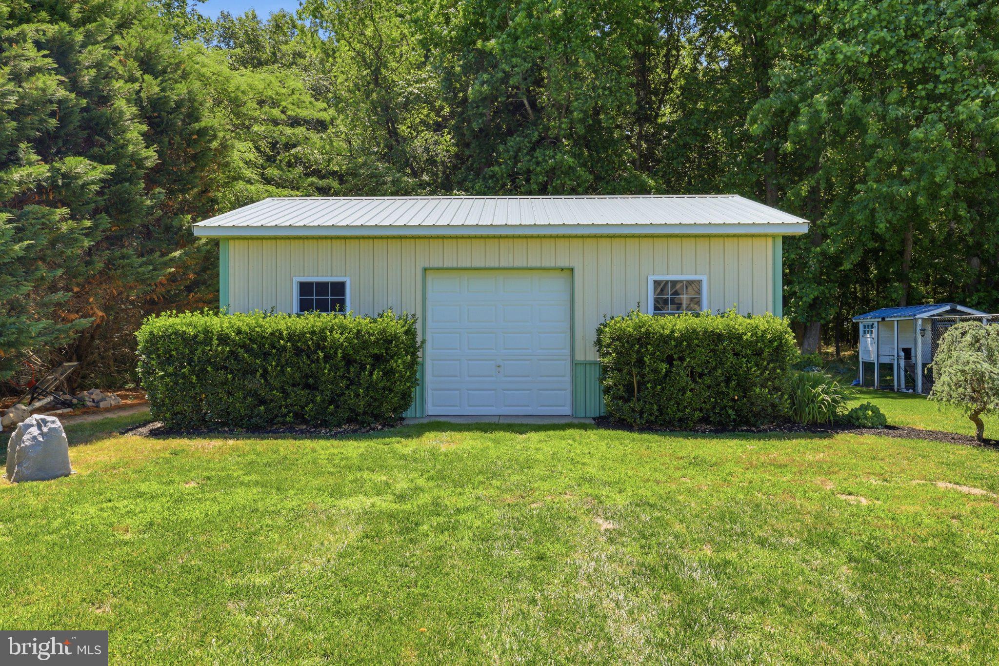 16932 Fitzgeralds Road Lincoln, DE 19960 - Photo 13 of 103 Charming shed nestled in lush greenery.