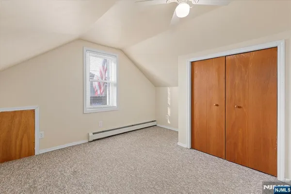 an empty room with windows and closet