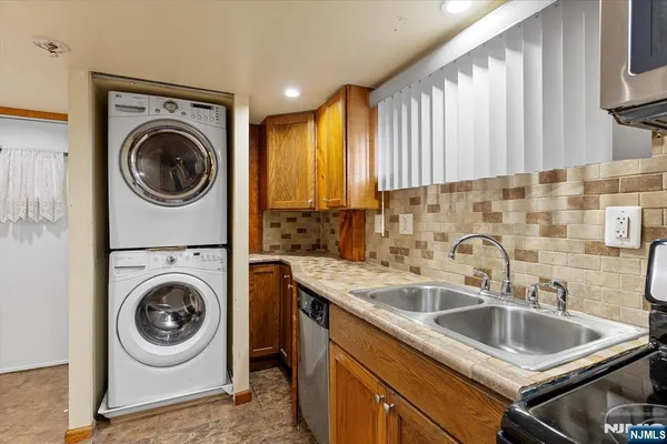 a utility room with sink dryer and washer