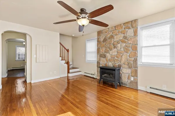 wooden floor fireplace and windows in an empty room