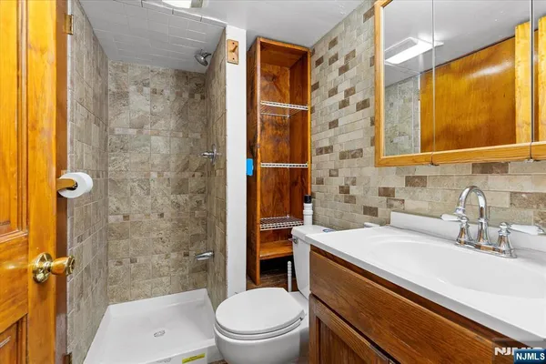 a bathroom with a sink a toilet and shower