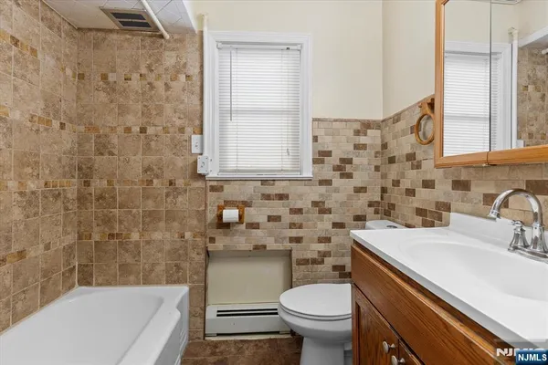 a bathroom with a sink a toilet and a bathtub