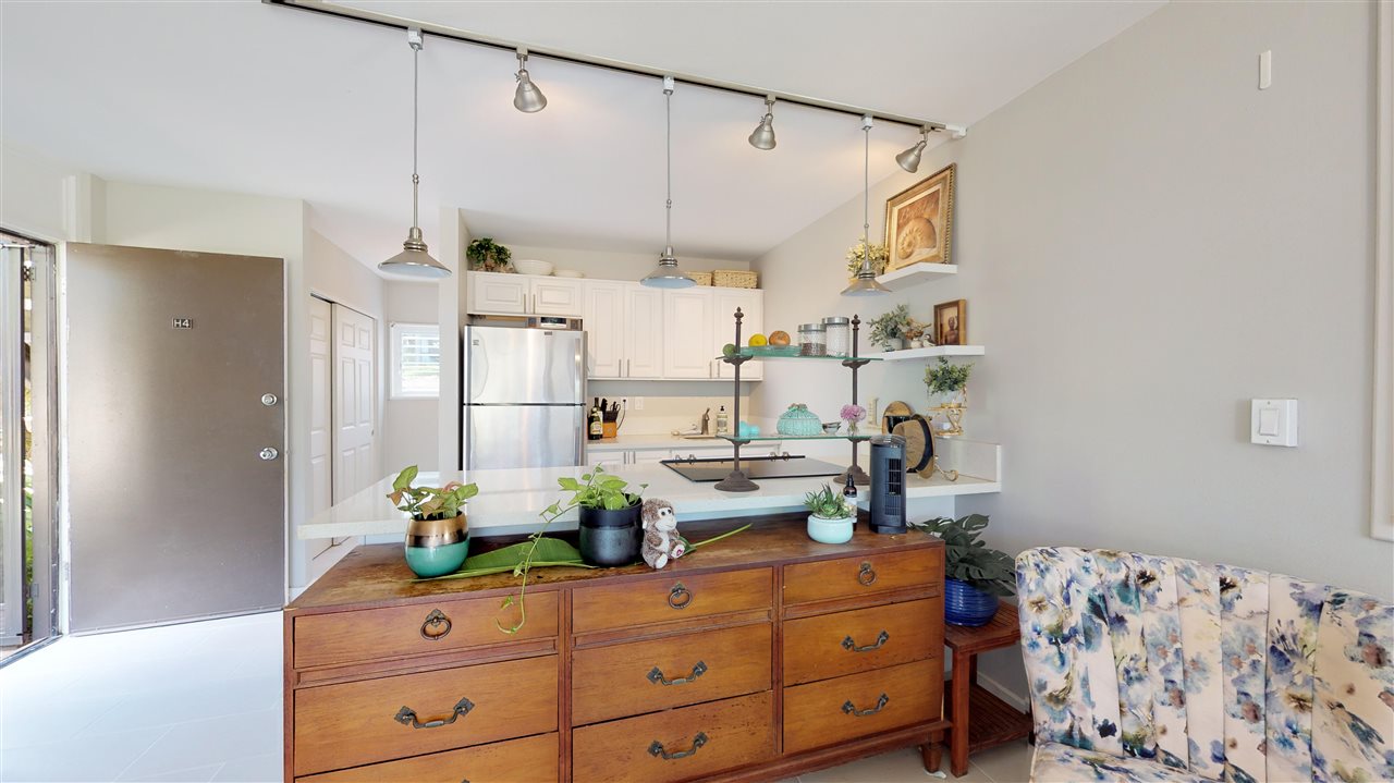 120 Hui Rd F, Unit H4 Lahaina, HI 96761 - Photo 13 of 21 a kitchen with stainless steel appliances kitchen island granite countertop cabinets and wooden floor