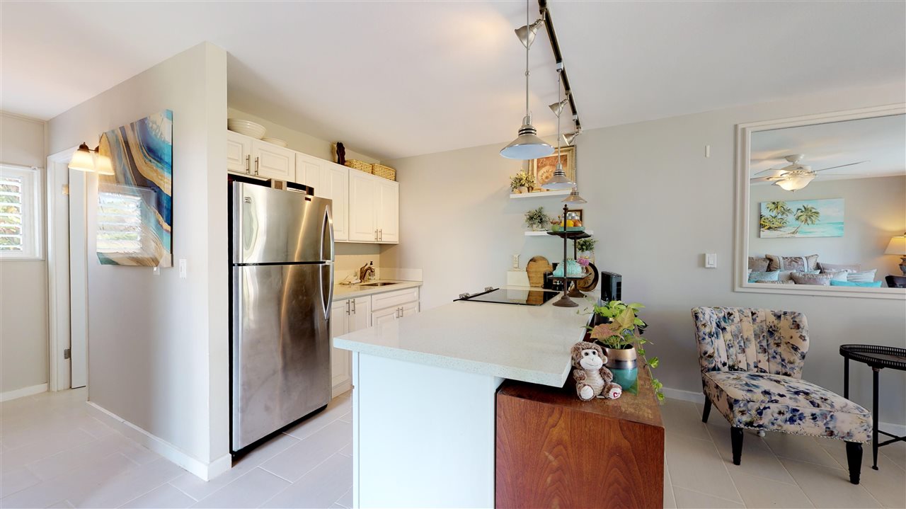 120 Hui Rd F, Unit H4 Lahaina, HI 96761 - Photo 17 of 21 a kitchen with stainless steel appliances a refrigerator and a table