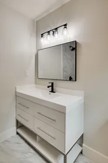 a bathroom with a sink and mirror