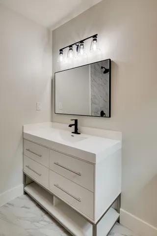 a bathroom with a sink and mirror