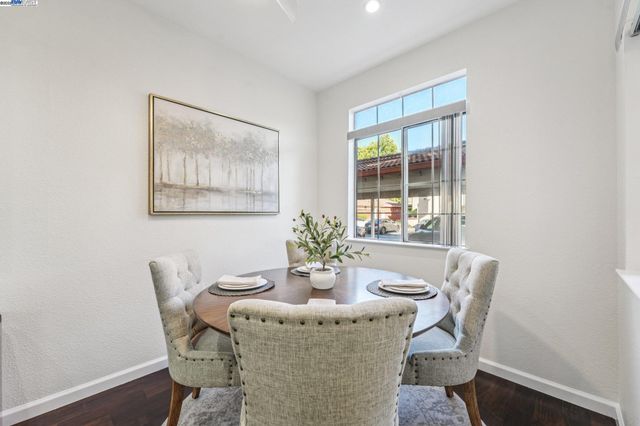 a dining room with furniture and wooden floor