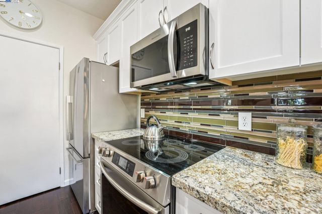 a kitchen with a stove and a microwave