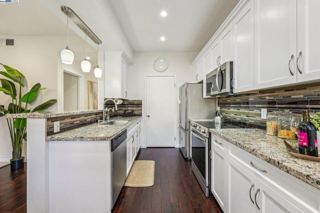 a kitchen with a sink stove and cabinets