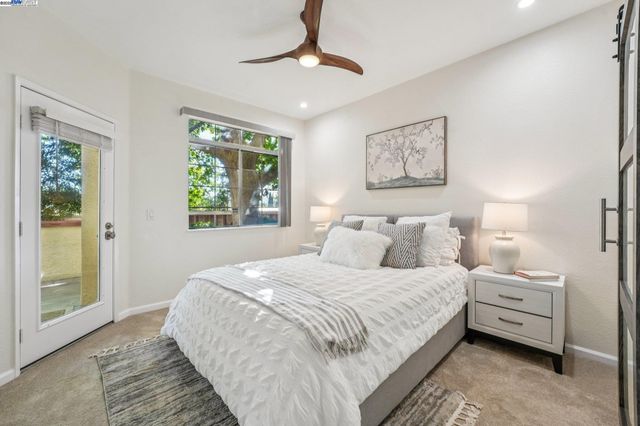 a bedroom with a large bed and a window