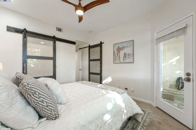 a bedroom with a large bed and a chandelier