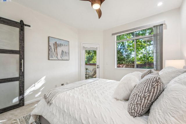 a bedroom with a large bed and a window