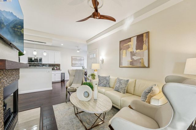 a living room with furniture and kitchen view