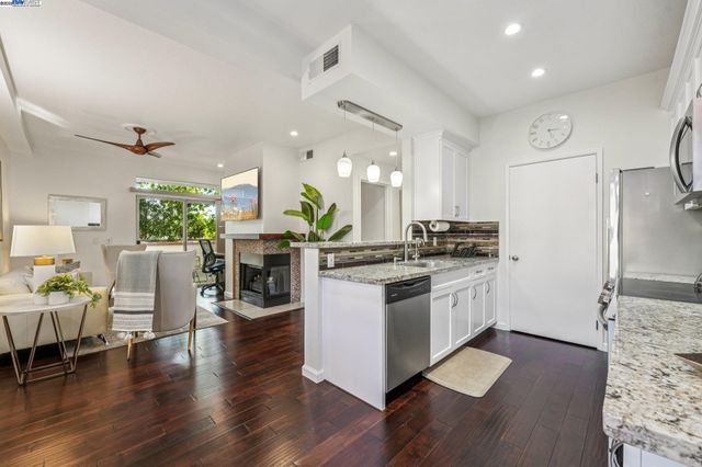 a kitchen with a table chairs refrigerator and cabinets