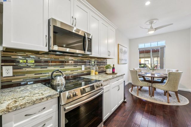 a kitchen with a stove a sink and a microwave