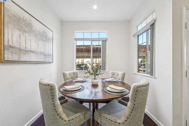 a view of a dining room with furniture and window
