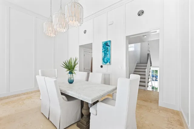 a living room with furniture a flat screen tv and a potted plant