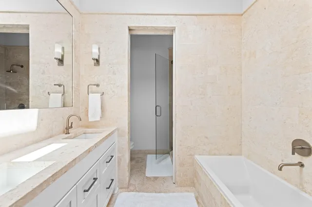 a bathroom with a double vanity sink and a mirror