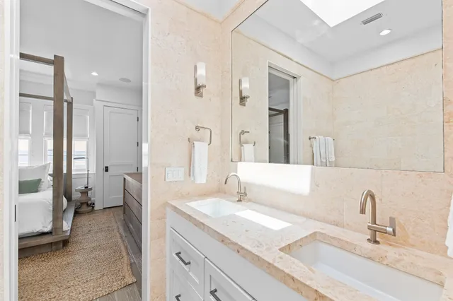 a bathroom with a granite countertop sink a toilet and shower