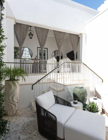 a roof deck with couches and ocean view