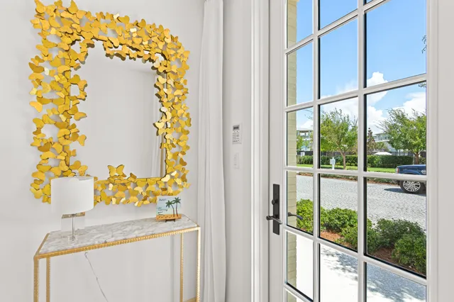 a view of a dining room with furniture a livingroom and chandelier