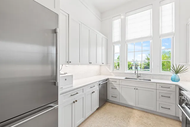 a kitchen with a sink and refrigerator