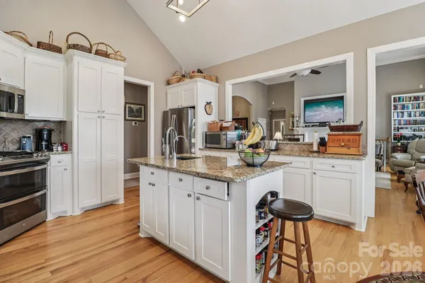 a living room with furniture fireplace and a chandelier