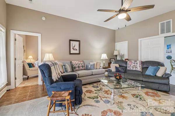 a living room with furniture and a chandelier