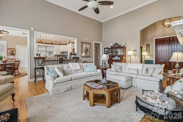 a bedroom with a bed a couch and large window