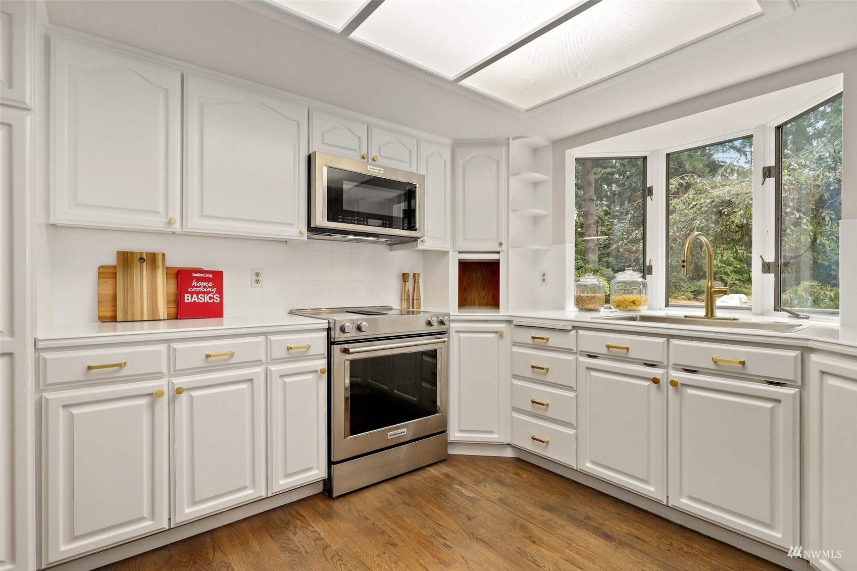 17521 5th Avenue West Bothell, WA 98012 - Photo 11 of 40 a kitchen with white cabinets stainless steel appliances and sink