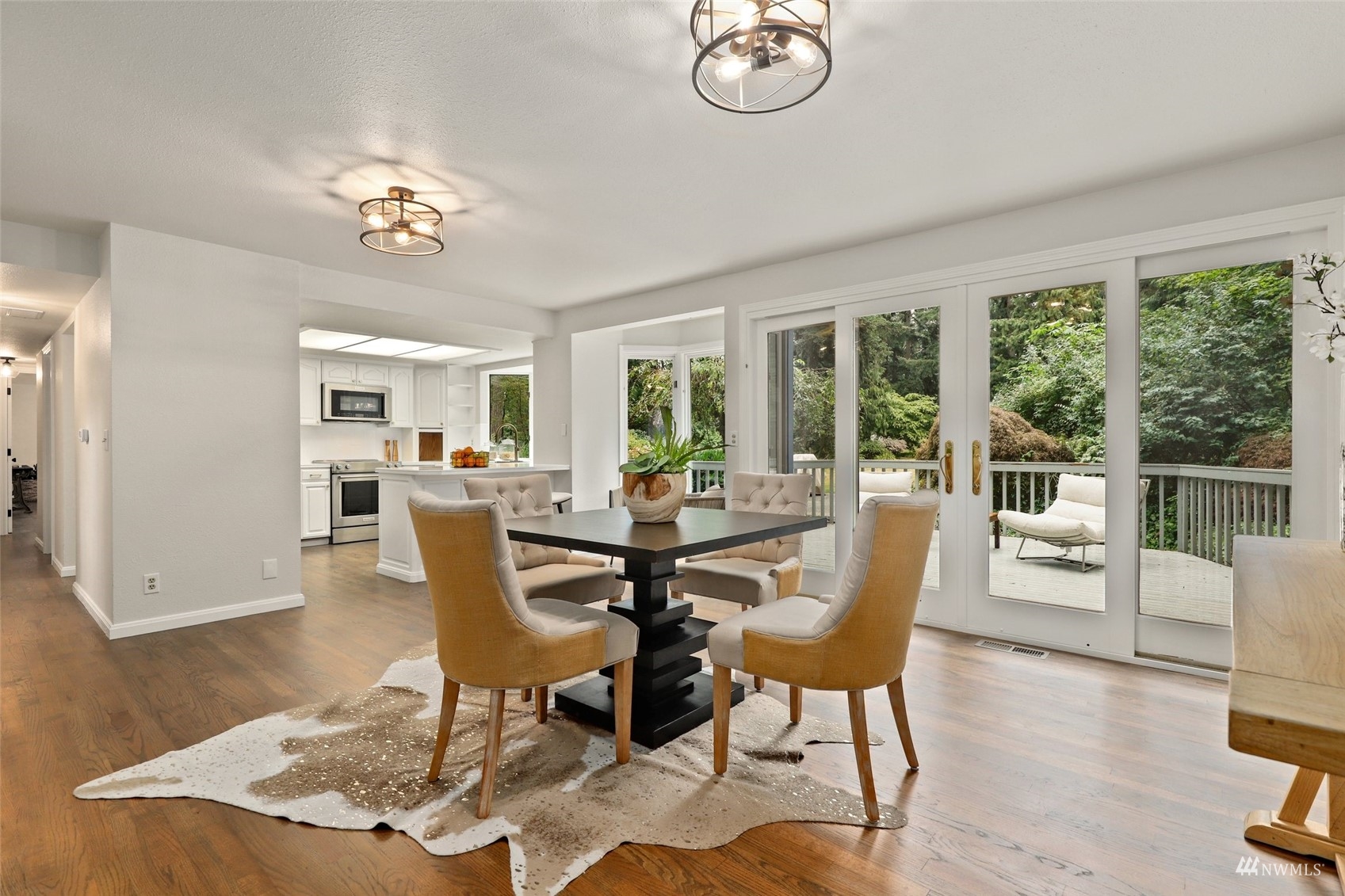 17521 5th Avenue West Bothell, WA 98012 - Photo 15 of 40 a view of a dining room with furniture a chandelier and wooden floor