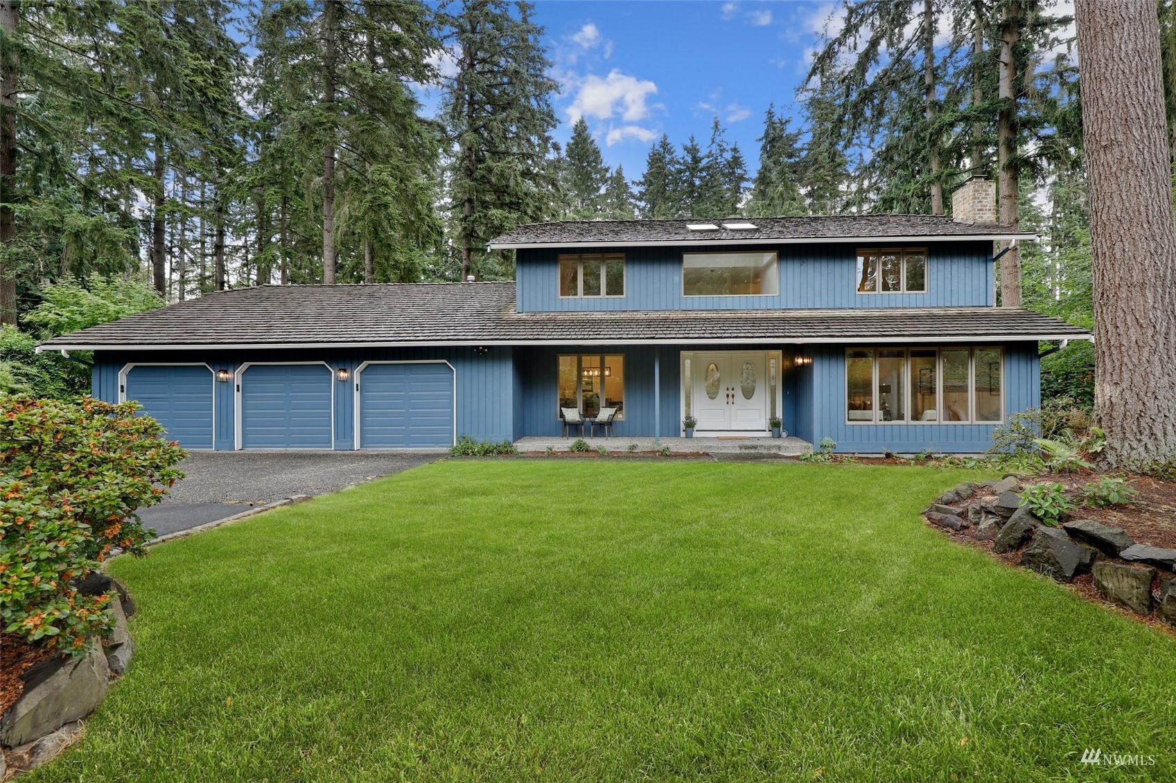 17521 5th Avenue West Bothell, WA 98012 - Photo 2 of 40 a view of a yard in front of a house with large trees
