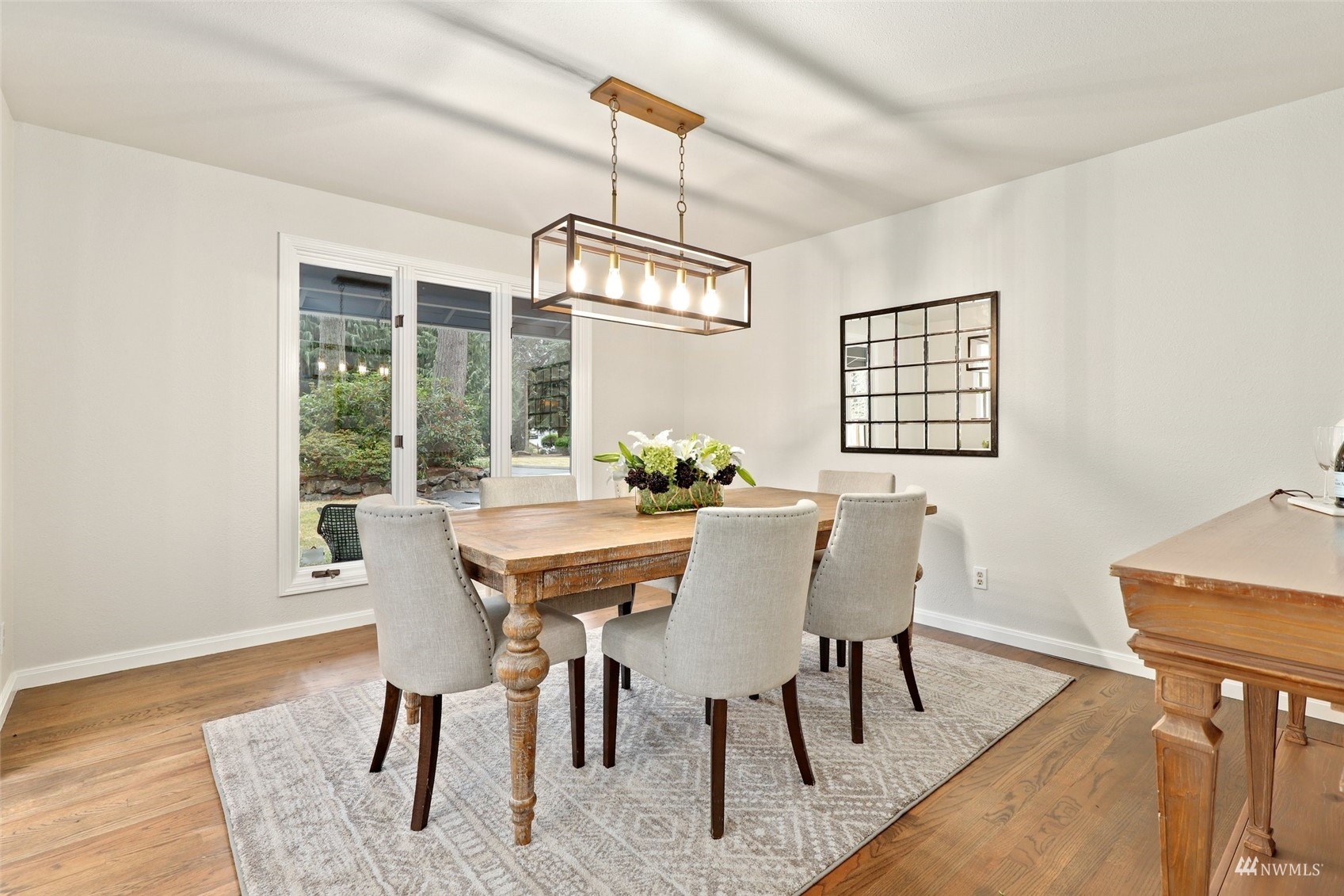 17521 5th Avenue West Bothell, WA 98012 - Photo 8 of 40 a view of a dining room with furniture window and wooden floor