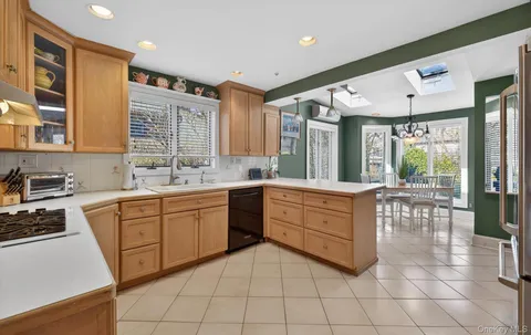 a kitchen with a sink window and cabinets