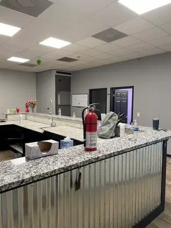 a view of cabinets a sink dishwasher and wooden floor