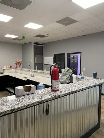a view of cabinets a sink dishwasher and wooden floor