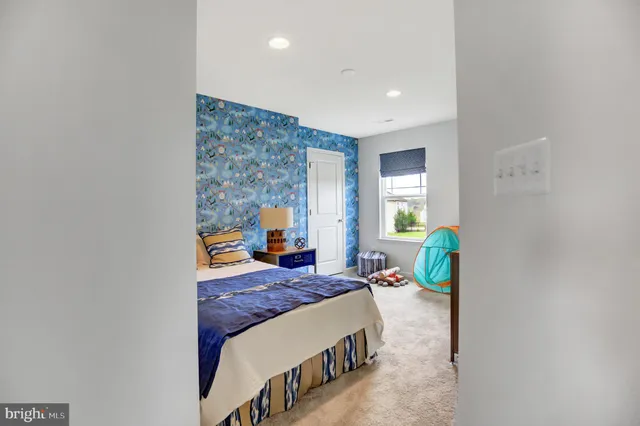 a bedroom with a bed window and wall painting