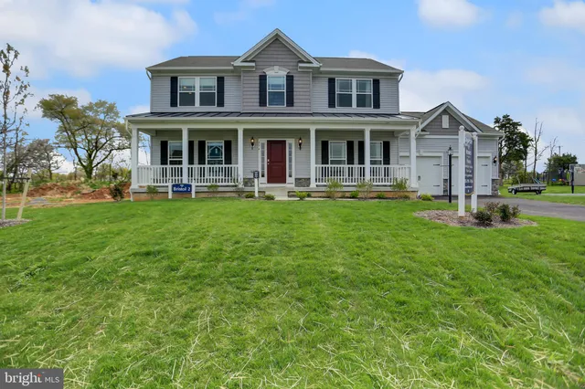 a front view of a house with a garden and patio