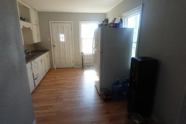 a kitchen with a refrigerator and a stove top oven