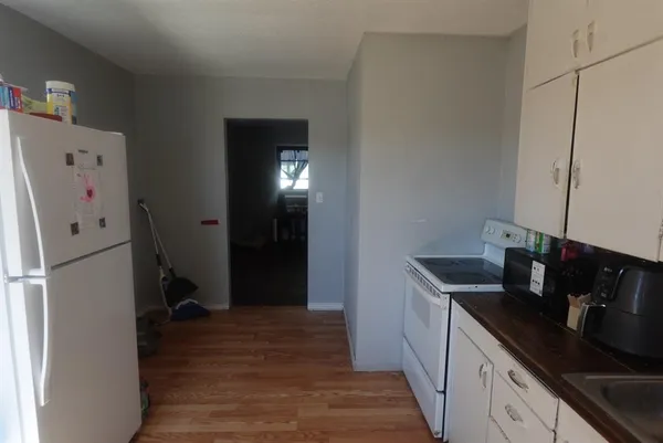 a kitchen with a refrigerator and cabinets