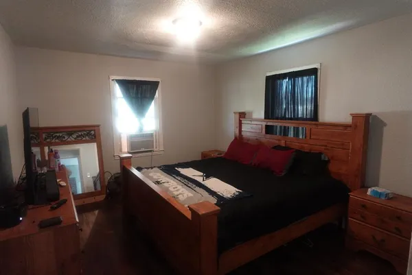 a bed sitting in a bedroom next to a window