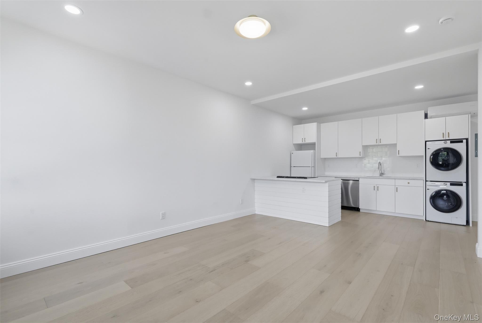 207 Main Street, Unit 3 Beacon, NY 12508 - Photo 11 of 23 a view of a kitchen with a sink and white cabinets