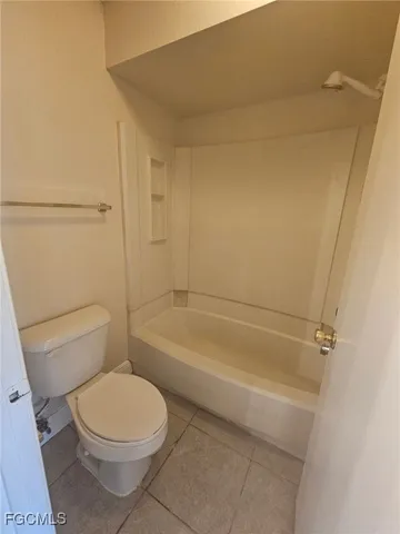 a bathroom with a toilet and a bathtub