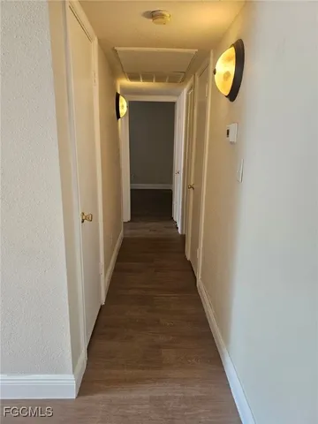 a view of a hallway with wooden floor and entryway