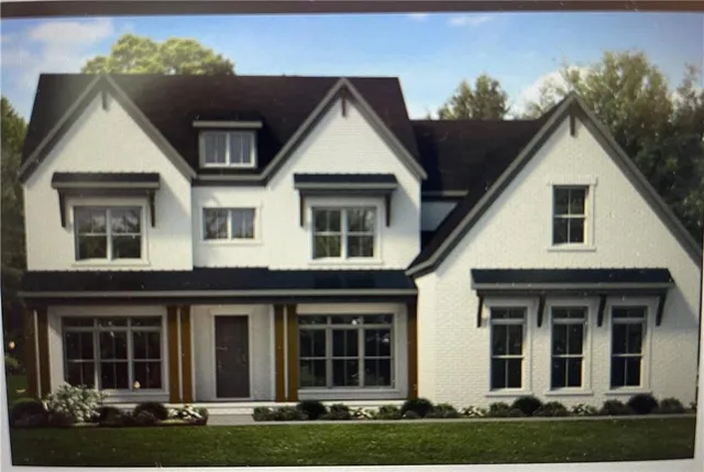 a view of a white house with large windows and a yard in front of it