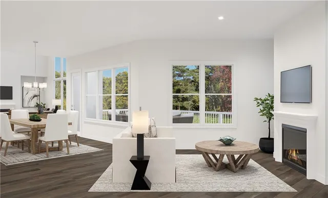 a living room with fireplace furniture and a large window