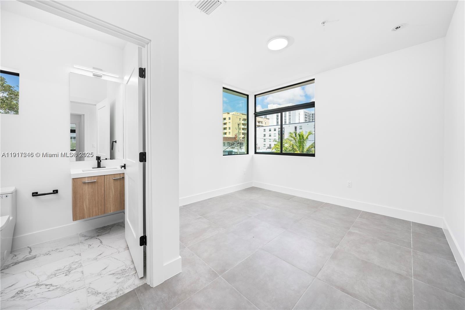 1780 Southwest 5th Street, Unit 1 Miami, FL 33135 - Photo 21 of 29 a view of a bathroom with a sink and a tub