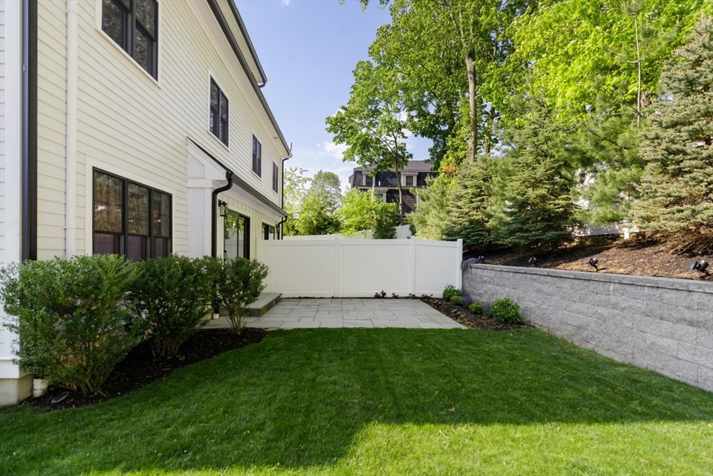 1124 Chestnut Street Newton, MA 02464 - Photo 36 of 41 a view of a white house with a yard and plants
