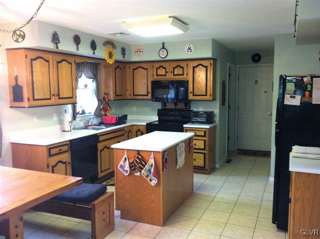 129 West Aluta Mill Road Nazareth, PA 18064 - Photo 9 of 39 a kitchen with a refrigerator and a stove